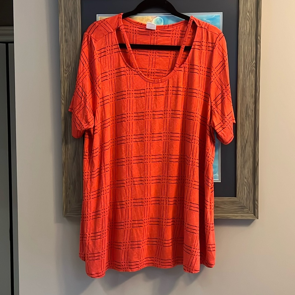 Orange with brown lines. Very comfortable lightweight top.